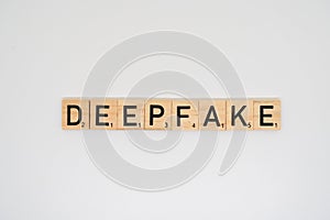 Wooden tile spelling the word deepfake isolated on a white background