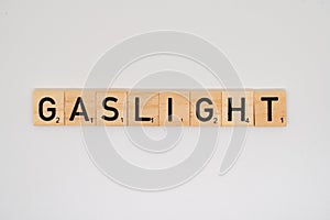 Wooden tile spelling the word gaslight isolated on a white background