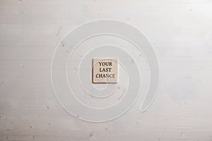Wooden tile with an Your last chance written on it