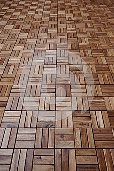 Wooden tiles, weatherproof, on the floor of the terrace of a residential building photo