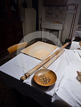 Wooden tools for preparing homemade pasta in an old kitchen of an Italian village