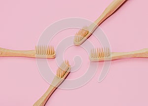 Wooden toothbrushes on pink background