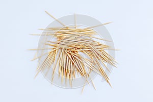 Wooden toothpicks in bulk on  white background close-up