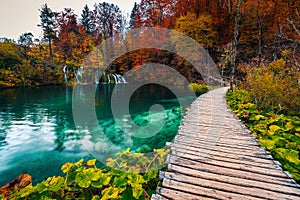 Wooden touristic footbridge over the clean lake, Plitvice lakes, Croatia