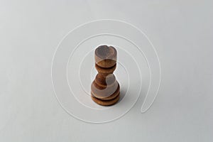 Wooden tower chess figure on grey background