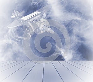 Wooden toy airplane with solar panel over a blue wood, on blue sky and cloud background.