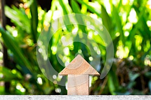 Wooden toy as dream house concept with blur green background