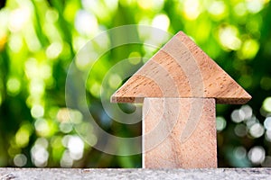 Wooden toy as dream house concept with blur green background