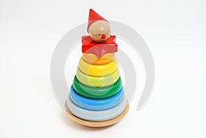 Wooden toy for baby, children isolated on white background. Rings of different colors and sizes are stacked. People with hat