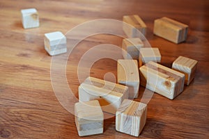 Wooden toy blocks and cubes on brown floor