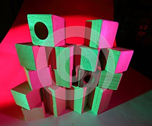 Wooden toy bricks in colored light