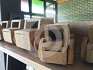 Wooden toy car arranged on the counter bar indoors