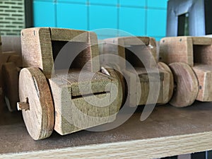 Wooden toy car arranged on the counter bar indoors