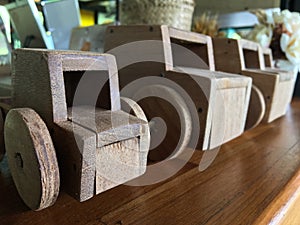 Wooden toy car arranged on the counter bar indoors