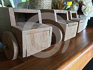 Wooden toy car arranged on the counter bar indoors