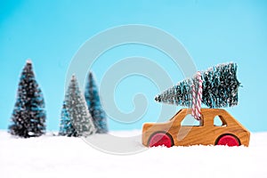 Wooden toy car carrying Christmas tree