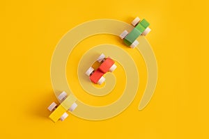 Wooden toy car in cartoon style on yellow background. Colorful and Transportation background, eco kid toys Montessori .