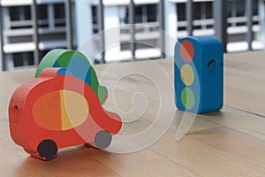 Wooden toy cars with traffic light on the table.