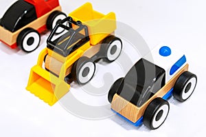 Wooden toy cars on a white background