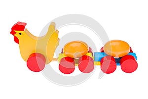 Wooden toy, chicken and eggs. On a white background, isolated