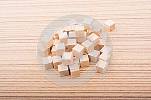 Wooden toy cubes as  educational game object on wooden background