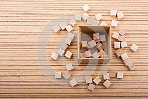 Wooden toy cubes as  educational game object on wooden background