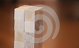 Wooden toy cubes on a brown wooden background. Building construction concept, business startup concept