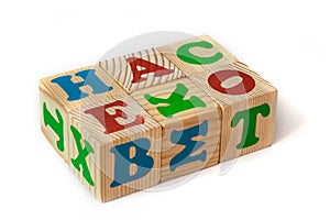 Wooden toy cubes with letters isolated on white background