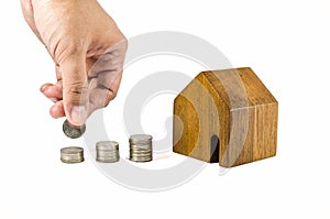Wooden toy house with coins concept photo
