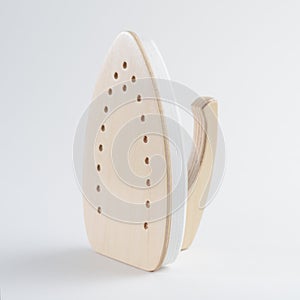 Wooden toy iron on white background