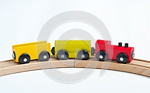 Wooden toy train with colorful blocks on a wooden railway. Educational toys