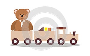 Wooden toy train with colorful blocs and teddy bear photo