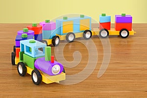 Wooden toy train with colorful blocs on the wooden table. 3D rendering