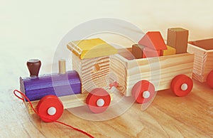 Wooden toy train over wooden table.