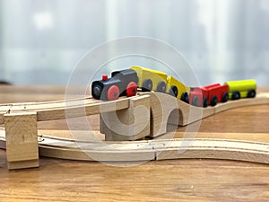 Wooden toy train on wooden rail.