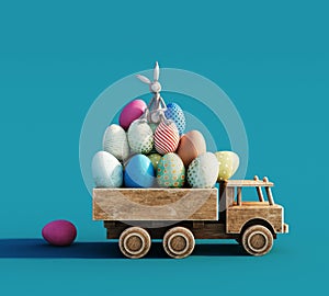 Wooden toy truck loaded with colorful Easter eggs bunny toy on blue background