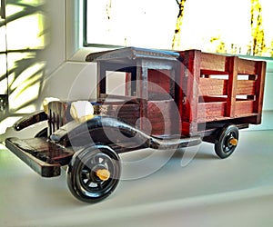 A wooden toy vintage brown dump truck