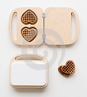 Wooden toy waffle makers and chocolate waffles. Waldorf toys on white background