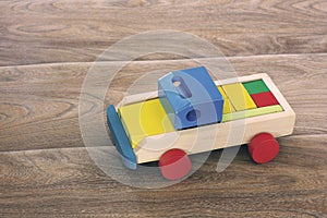 Wooden toy on a wooden background. Car
