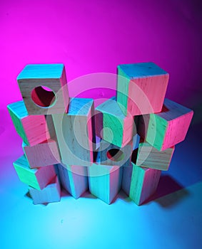 Wooden toy bricks in colored light