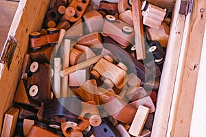 Wooden toys on a wooden box. Close-up hands.