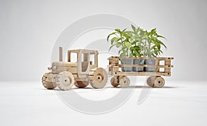 Wooden tractor with trailer, transports small trees. Concept of safeguarding nature and the environment and deforestation. Concept photo