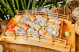 Wooden Tray Filled With Assorted Sushi Rolls