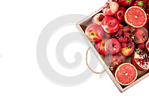 Wooden tray with fresh red vegetables and fruits on white background. Healthy eating vegetarian concept.