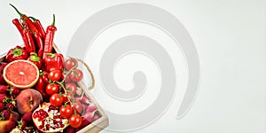 Wooden tray with fresh red vegetables and fruits on white background. Healthy eating vegetarian concept.