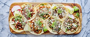 Wooden tray full of mexican street tacos photo