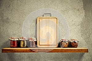 Wooden tray with some jars on wooden shelf. Copy empty space for your decoration and products. Beige brown retro wall background.