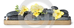 Wooden tray with spa stones and freesia flowers