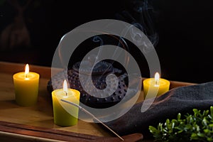 Wooden tray with teapot and ornamental objects from oriental culture. Selective focus