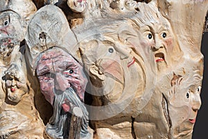 Wooden Tree Sculpture: Close-up of Faces Carved in Wood, Handmade
